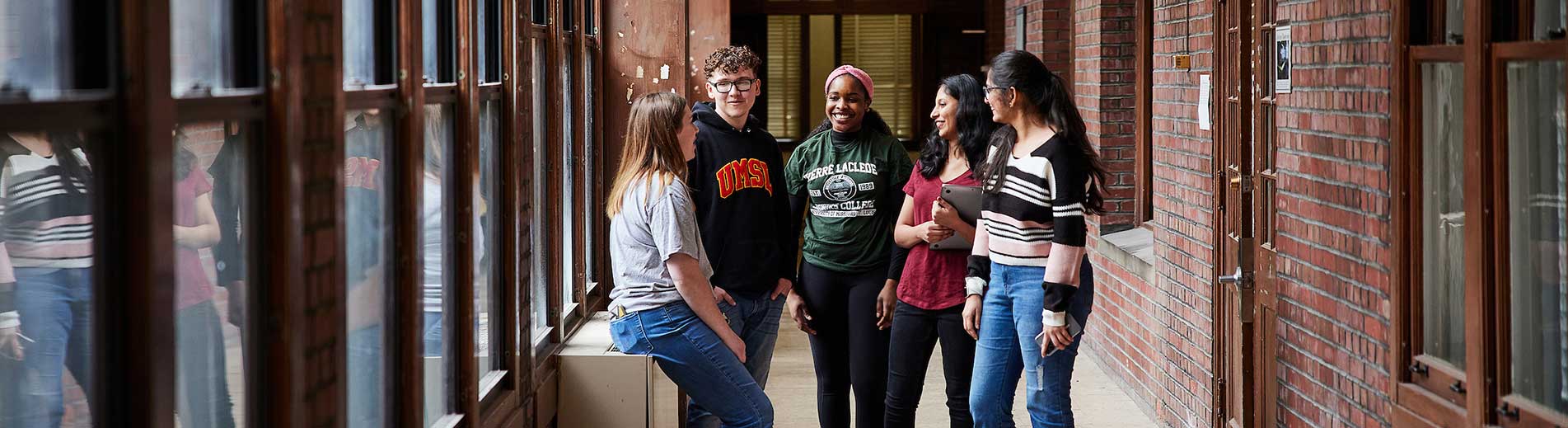 students talking in a hallway of the campus