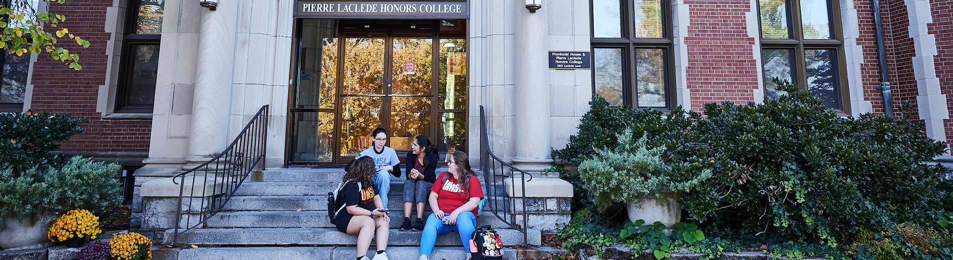 students sitting on the stairs on campus