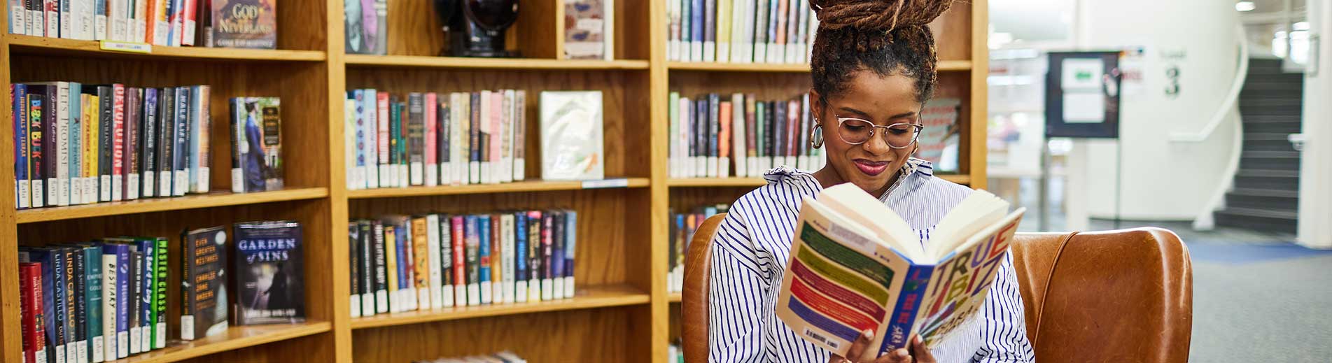 student reading in a library