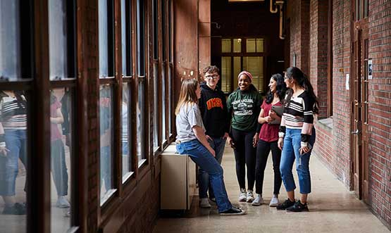 students talking in a hallway of the campus