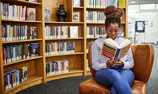 student reading in a library