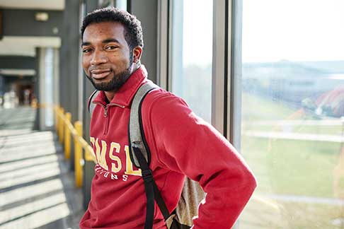 student with a red UMSL sweatshirt